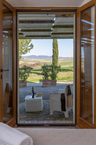 a room with a glass door with a view of a patio at Agriturismo San Marcello in Castiglione dʼOrcia