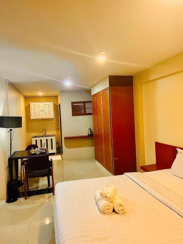 Postel nebo postele na pokoji v ubytování MK Residence, Pattaya