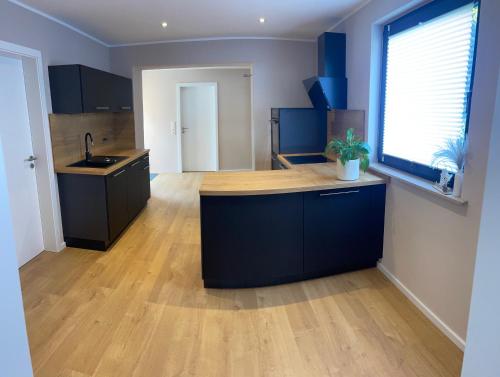 a kitchen with blue cabinets and a wooden counter top at Ferienhaus Scheid in Bremm