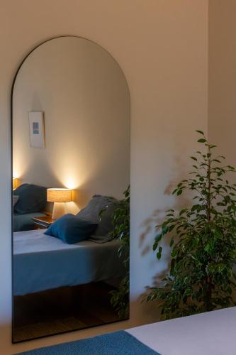 a bedroom with a bed and a potted plant at Casa da Câmara in Tondela