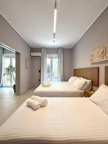 a hotel room with two beds with towels on them at Acropolis Path - Elegant Apartment near Plaka in Athens