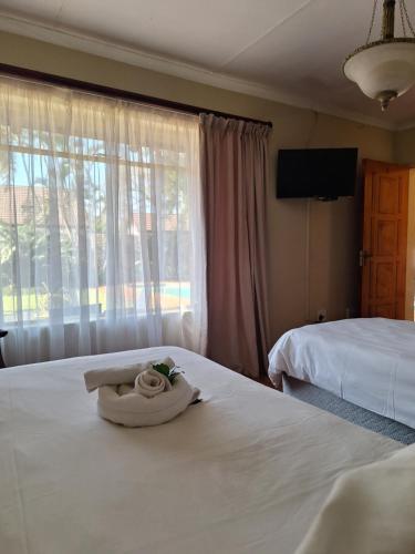 Ένα ή περισσότερα κρεβάτια σε δωμάτιο στο Cycas Guest House