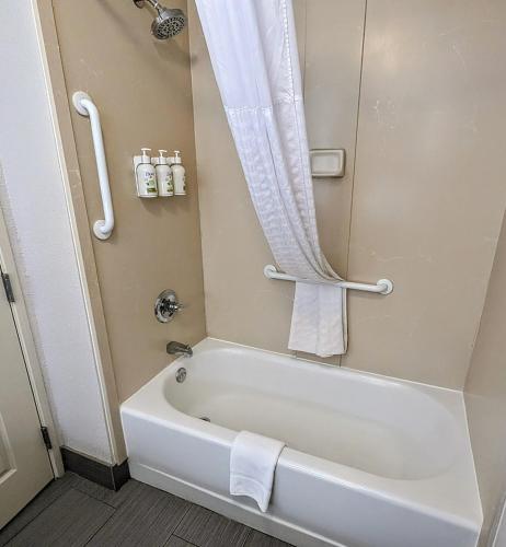 a bathroom with a white tub and a shower at La Quinta by Wyndham Prattville in Prattville
