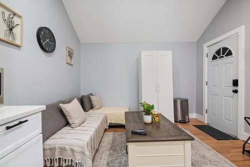 a living room with a couch and a table at Lunavista Cozy Studio in Hempstead