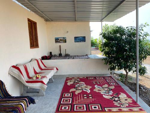 a living room with two couches and a rug at Mangal Srushti Agro Tourism 