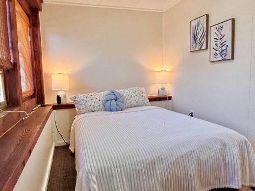 a bedroom with a bed with two lamps on the wall at Cozy Main Level Torch Lake Stay with Private Entry & Fire Pit in Rapid City