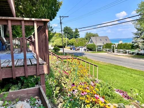 a garden with flowers on the side of a house at Cozy Main Level Torch Lake Stay with Private Entry & Fire Pit in Rapid City