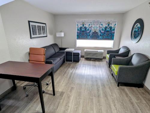 a living room with couches and a table at La Quinta by Wyndham Prattville in Prattville