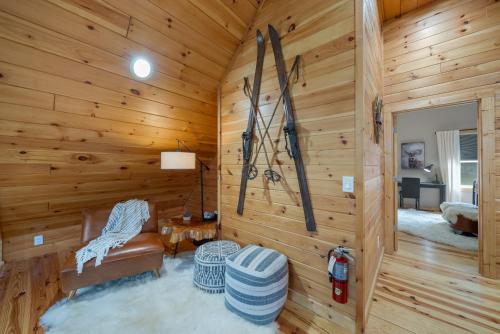 a room with skis on the wall in a log cabin at Pine Ridge Retreat in Beech Mountain