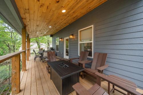 a wooden deck with a table and chairs on it at Pine Ridge Retreat in Beech Mountain