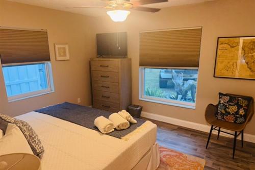 a bedroom with a bed with two pillows on it at Gorgeous vacation home on the water with heated pool and sand! in Hernando Beach