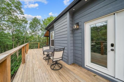 a deck with two chairs and a table at Pine Ridge Retreat in Beech Mountain