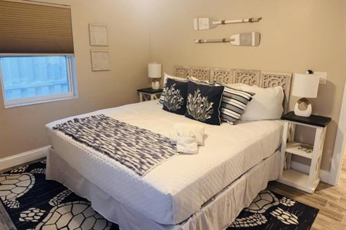 a bedroom with a large bed and a window at Gorgeous vacation home on the water with heated pool and sand! in Hernando Beach