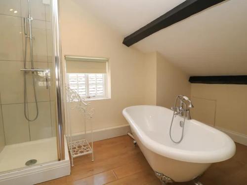 a bathroom with a tub and a sink and a shower at Bay House in Broadway