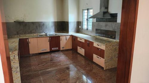 a kitchen with wooden cabinets and a sink in it at vaibhav farm house in Govindgarh Malkpur