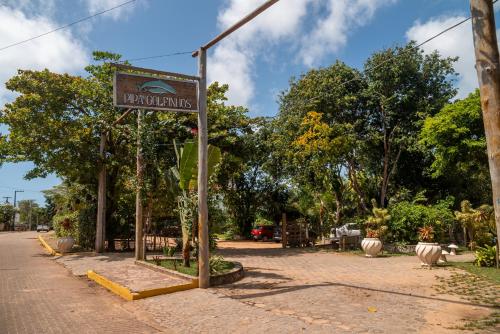 a sign for a parrot park on a street at Pipa Golfinhos Pousada in Pipa