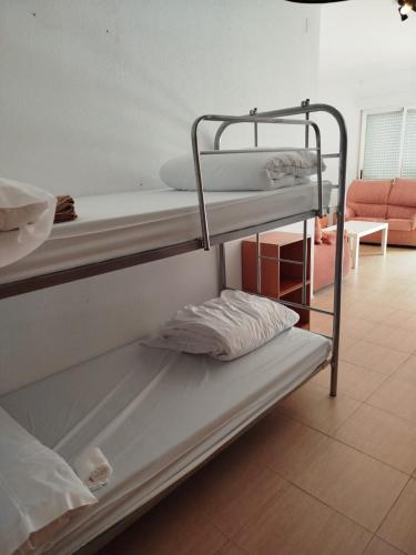 a couple of bunk beds in a room at Albergue turistico diversion sur in Horcajo de Santiago