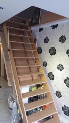 a stairway with wooden drawers in a room at HomeStay Sandra in Hockenheim