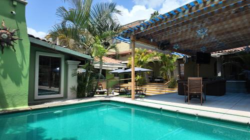 a swimming pool in front of a house at Hacienda del Lago Boutique Hotel in Ajijic