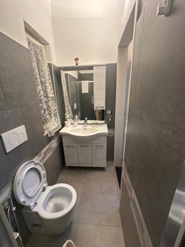 a bathroom with a toilet and a sink at Alloggio Fiorella in Rome