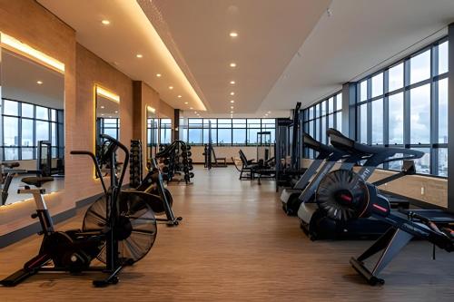 a gym with treadmills and cardio equipment in a building at Suíte Black Premium in Goiânia
