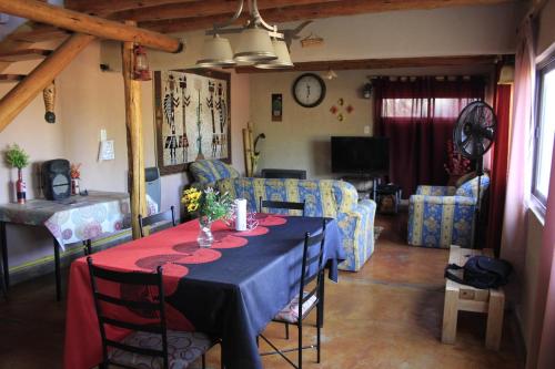 a living room with a table and a couch at Manantial in Guaymallen