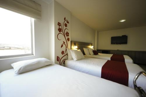 Katil atau katil-katil dalam bilik di Hotel MH Pereira