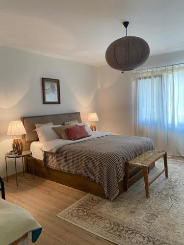 a bedroom with a large bed and a pendant light at Altun's Home in Trabzon