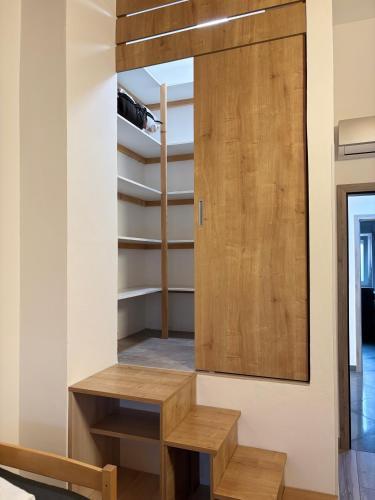 a room with a wooden door and a wooden bench at Villa Silver Novigrad with private pool in Novigrad Istria