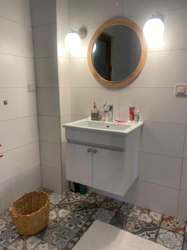 a bathroom with a white sink and a mirror at Altun's Home in Trabzon