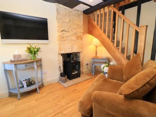 a living room with a couch and a fireplace at Bay House in Broadway