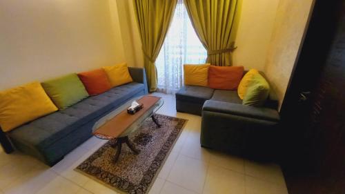 a living room with a couch and a coffee table at Bahria Town Apartment in Karachi