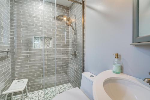 a bathroom with a shower with a toilet and a sink at Spacious Riverfront Home with Dock in St Clair! in St. Clair