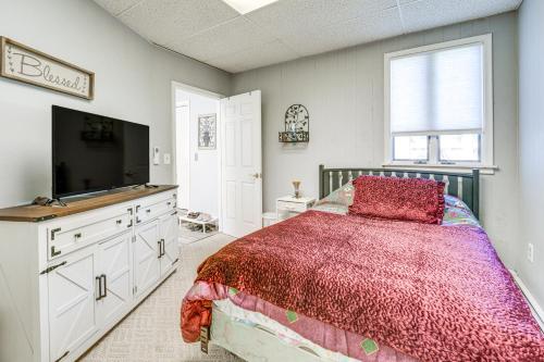 a bedroom with a bed and a flat screen tv at Spacious Riverfront Home with Dock in St Clair! in St. Clair