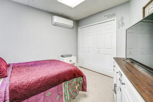 a bedroom with a bed and a flat screen tv at Spacious Riverfront Home with Dock in St Clair! in St. Clair