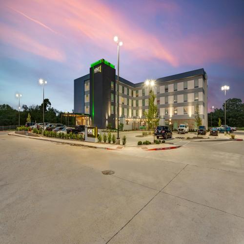 a large building with cars parked in a parking lot at Home2 Suites By Hilton Fort Worth Arlington West in Fort Worth