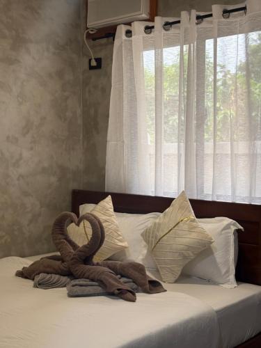 a heart made out of towels on a bed at Solana Inn El Nido in El Nido