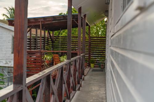 a deck with a wooden fence and stairs at Casa De Shangrila in Belize City
