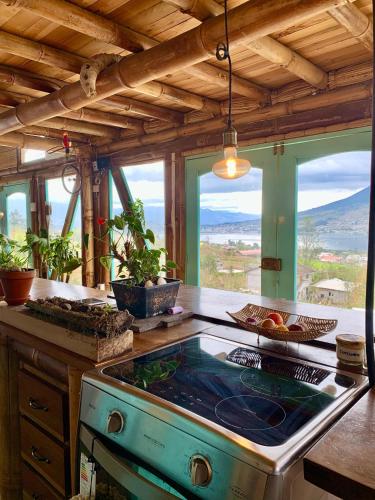 a kitchen with a stove and some windows at Chalet de Bambú Urku Wasi in Otavalo
