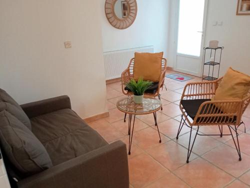 a living room with a couch and chairs and a table at Chez Dominique et Jean-Louis - Logement T2 50m2 in Tourves