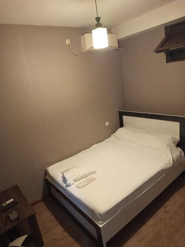 a bed with two towels on it in a room at კაველა 555 in Tbilisi City