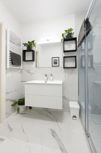 a white bathroom with a sink and a toilet at LB - Luna Luxury Suite in Bergamo
