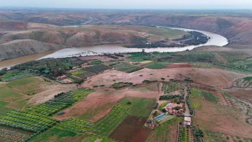 an aerial view of a river and a field at Kasbah Oum Rabia in Boulaouane
