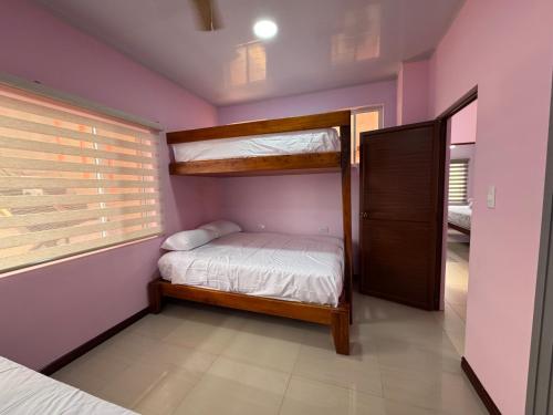 a bedroom with bunk beds and a window at BeachClub Tonsupa by Cascada Spa Ecuador in Tonsupa