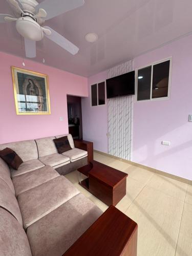 a living room with a couch and a ceiling fan at BeachClub Tonsupa by Cascada Spa Ecuador in Tonsupa