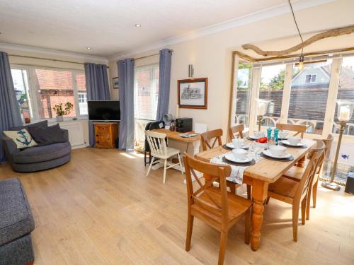 a dining room and living room with a table and chairs at Riverview in Hamble