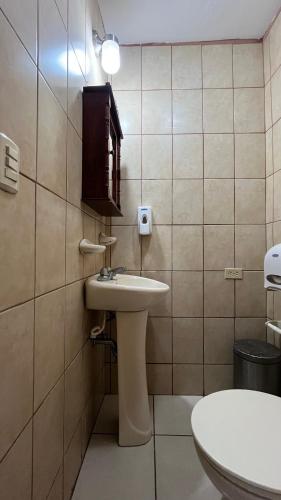 a bathroom with a sink and a toilet at Hotel Casa Morazán in Granada