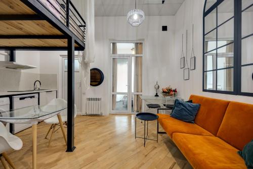 a living room with a couch and a table at Freedom Square - Poets' Nest in Tbilisi City