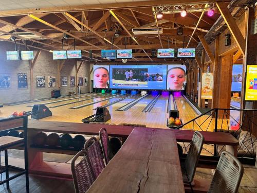 a bowling alley with a game console and lanes at Très beau Mobil Home 40 m2 3Ch - Camping 4 étoiles Les Charmettes 370- proche FUN ZONE in Les Mathes