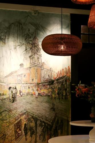 a wall with a painting of a clock tower at The Hostel Santiago in Santiago